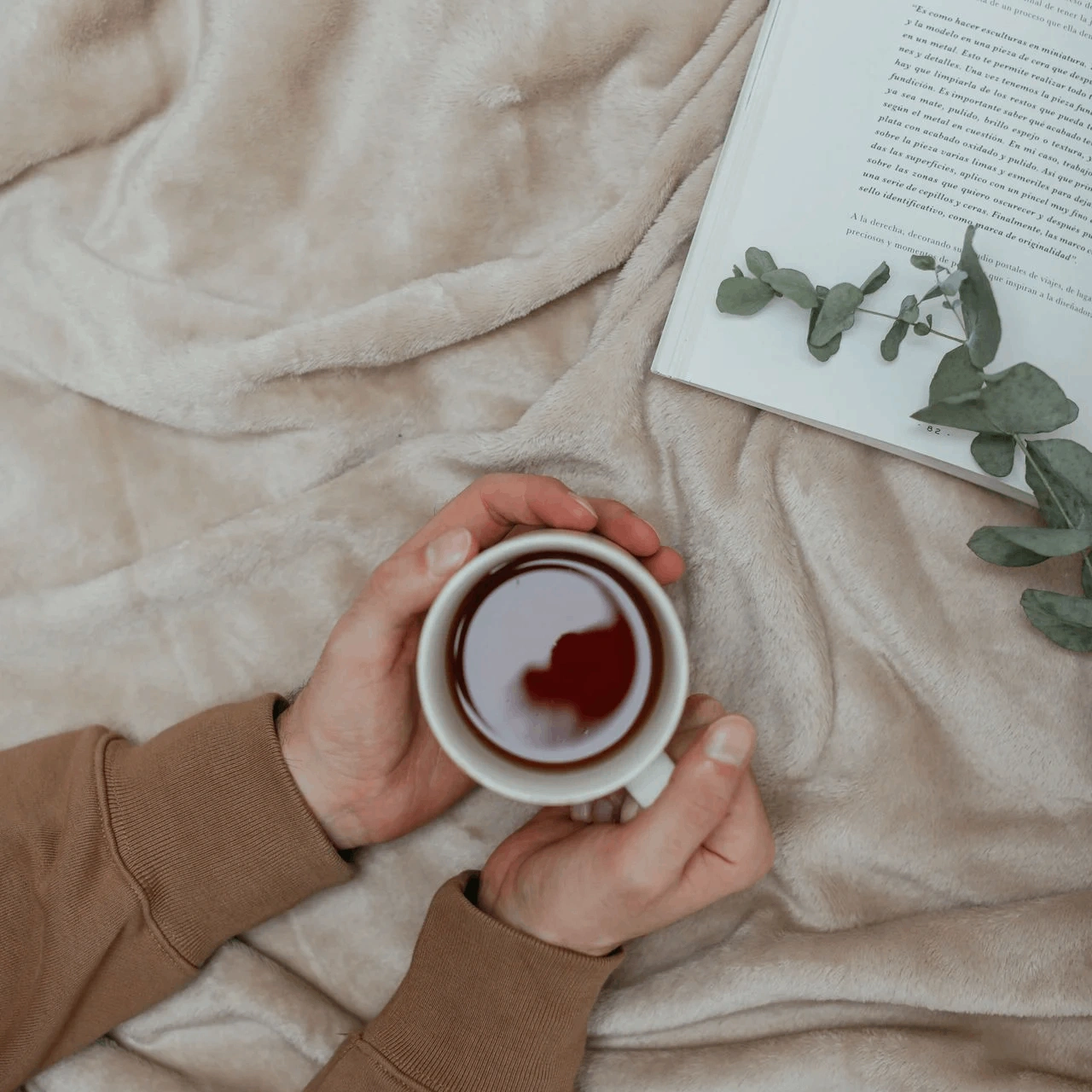 A cup of tea resting on a wooden table